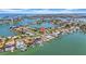 Beautiful waterfront homes featuring boat docks, lush landscaping, and a serene bay view from above at 8001 13Th S Ave, St Petersburg, FL 33707