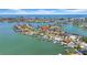 An aerial view of homes on a peninsula with boat docks, lush greenery, and a beautiful ocean backdrop at 8001 13Th S Ave, St Petersburg, FL 33707