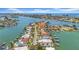 A waterfront community with canals, boat docks, lush landscaping, and beautiful homes from an aerial perspective at 8001 13Th S Ave, St Petersburg, FL 33707