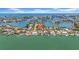 Stunning aerial view of waterfront homes with private docks, lush landscaping, and serene bay waters in the distance at 8001 13Th S Ave, St Petersburg, FL 33707
