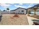 Backyard features a fire pit, gravel landscaping and an outdoor dining area at 8001 13Th S Ave, St Petersburg, FL 33707
