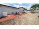 Backyard with gravel, brick pathway, and patio area at 8001 13Th S Ave, St Petersburg, FL 33707