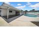 A view of the backyard with a patio, pool, and fence surrounding the property at 8001 13Th S Ave, St Petersburg, FL 33707