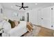 Bright bedroom with hardwood floors, white walls, and a stylish ceiling fan at 8001 13Th S Ave, St Petersburg, FL 33707