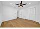 Bedroom featuring hardwood floors, a ceiling fan, and dual closet space at 8001 13Th S Ave, St Petersburg, FL 33707