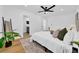 Bright bedroom with hardwood floors, white walls, and a view into the en suite bath at 8001 13Th S Ave, St Petersburg, FL 33707