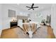 Bright bedroom with hardwood floors, white walls, and a cozy decorative blanket on the bed at 8001 13Th S Ave, St Petersburg, FL 33707