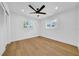 Cozy bedroom featuring hardwood floors, ceiling fan, and windows with bright natural light at 8001 13Th S Ave, St Petersburg, FL 33707