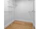Walk-in closet has hardwood floors, white walls, and wire shelving for optimal storage at 8001 13Th S Ave, St Petersburg, FL 33707