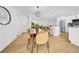 Dining room area with wood floors and modern lighting leading to the living and kitchen spaces at 8001 13Th S Ave, St Petersburg, FL 33707
