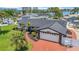 Single-story home featuring a well-kept lawn, landscaping, and a brick-paved driveway leading to a two-car garage at 8001 13Th S Ave, St Petersburg, FL 33707