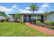 Beautiful one story home boasts a brick walkway and lush tropical landscaping at 8001 13Th S Ave, St Petersburg, FL 33707