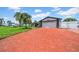 Single story home with a brick driveway and two-car garage at 8001 13Th S Ave, St Petersburg, FL 33707