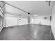 A spacious garage with white walls, a utility sink, and a door to the interior, providing ample space for storage at 8001 13Th S Ave, St Petersburg, FL 33707