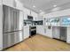 Renovated kitchen with stainless steel appliances, double oven, and ample cabinet space at 8001 13Th S Ave, St Petersburg, FL 33707
