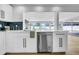 Bright, white kitchen featuring stainless steel dishwasher and a beautiful view to the outside at 8001 13Th S Ave, St Petersburg, FL 33707
