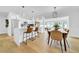 Open kitchen layout featuring white cabinets, a waterfall island, and stainless steel appliances at 8001 13Th S Ave, St Petersburg, FL 33707