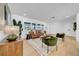 Living room with hardwood flooring, modern décor, and plantation shutters at 8001 13Th S Ave, St Petersburg, FL 33707