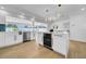 Open-concept with island wine cooler, extending to kitchen and living areas at 8001 13Th S Ave, St Petersburg, FL 33707