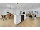 Open-concept living space with wine fridge, dining area, and cozy seating at 8001 13Th S Ave, St Petersburg, FL 33707