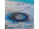 Aerial view of a crowded beach with people gathered in a circle on the sand at 915 Beach Rd # 321, Sarasota, FL 34242