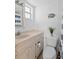 Cozy bathroom with a white vanity, a toilet, and a shower with a blue and white striped curtain at 915 Beach Rd # 321, Sarasota, FL 34242