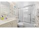 Bathroom with a shower over tub and a decorative wallpaper at 915 Beach Rd # 321, Sarasota, FL 34242