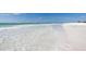 Gorgeous white sandy beach with clear, shallow water on a sunny day at 915 Beach Rd # 321, Sarasota, FL 34242