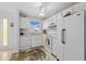 Well-lit kitchen with white appliances and floral rug offers a clean design at 915 Beach Rd # 321, Sarasota, FL 34242