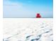 Scenic view of a red lifeguard tower on a bright white sandy beach under a clear blue sky at 915 Beach Rd # 321, Sarasota, FL 34242