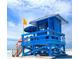 Charming blue lifeguard stand on a white sandy beach with a beautiful blue sky overhead at 915 Beach Rd # 321, Sarasota, FL 34242