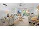 Bright living room featuring comfortable seating and sliding glass doors to a balcony at 915 Beach Rd # 321, Sarasota, FL 34242