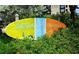 A sign for Siesta Key Village surrounded by greenery at 915 Beach Rd # 321, Sarasota, FL 34242