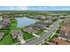 Aerial view of a new construction suburban neighborhood featuring ponds, green lawns, and well-maintained streets at 9291 Starry Night Ave, Sarasota, FL 34241