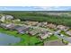 An aerial view of upscale homes with green lawns in the Skye Ranch community near a lush green forest at 9291 Starry Night Ave, Sarasota, FL 34241