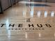 Shiny new indoor basketball court with the community logo on the floor at 9291 Starry Night Ave, Sarasota, FL 34241