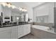 Luxurious bathroom with double vanity, soaking tub, and modern fixtures and plenty of light at 9291 Starry Night Ave, Sarasota, FL 34241