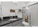 Bathroom featuring a dark countertop and shower with glass door, combining functionality and modern design at 9291 Starry Night Ave, Sarasota, FL 34241