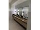 Stylish bathroom with a long wooden sink and modern fixtures at 9291 Starry Night Ave, Sarasota, FL 34241