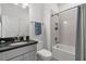 Bright bathroom with gray vanity, granite countertop, tub/shower combo, and stylish fixtures at 9291 Starry Night Ave, Sarasota, FL 34241