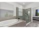 Elegant bathroom with a soaking tub and a large glass-enclosed shower and neutral design at 9291 Starry Night Ave, Sarasota, FL 34241