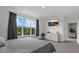Bright bedroom with large windows, gray decor, TV, and inviting neutral colored furniture at 9291 Starry Night Ave, Sarasota, FL 34241