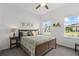 Inviting bedroom features two sunny windows, a decorative headboard, and neutral décor at 9291 Starry Night Ave, Sarasota, FL 34241