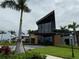 Attractive front view of the modern community clubhouse featuring contemporary design and lush greenery at 9291 Starry Night Ave, Sarasota, FL 34241
