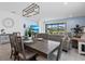 Dining area adjacent to living room and screened in lanai with view of the backyard at 9291 Starry Night Ave, Sarasota, FL 34241