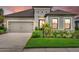 Charming single-Gathering home featuring a well-maintained lawn, neutral-toned exterior, and a two-car garage at 9291 Starry Night Ave, Sarasota, FL 34241