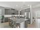 Kitchen with gray cabinets, stainless steel appliances, subway tile backsplash, and large center island at 9291 Starry Night Ave, Sarasota, FL 34241