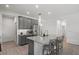 Kitchen island with sink and seating, gray cabinets, and stainless steel appliances at 9291 Starry Night Ave, Sarasota, FL 34241