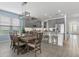 Kitchen and dining area with gray cabinets, stainless steel appliances, and kitchen island at 9291 Starry Night Ave, Sarasota, FL 34241