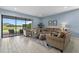Spacious living room with comfortable seating, stylish rug, and view of the screened lanai and water at 9291 Starry Night Ave, Sarasota, FL 34241